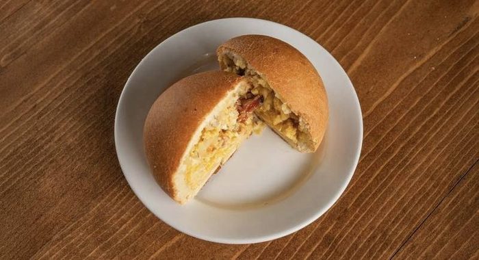 Bacon egg and cheese kolache on a plate