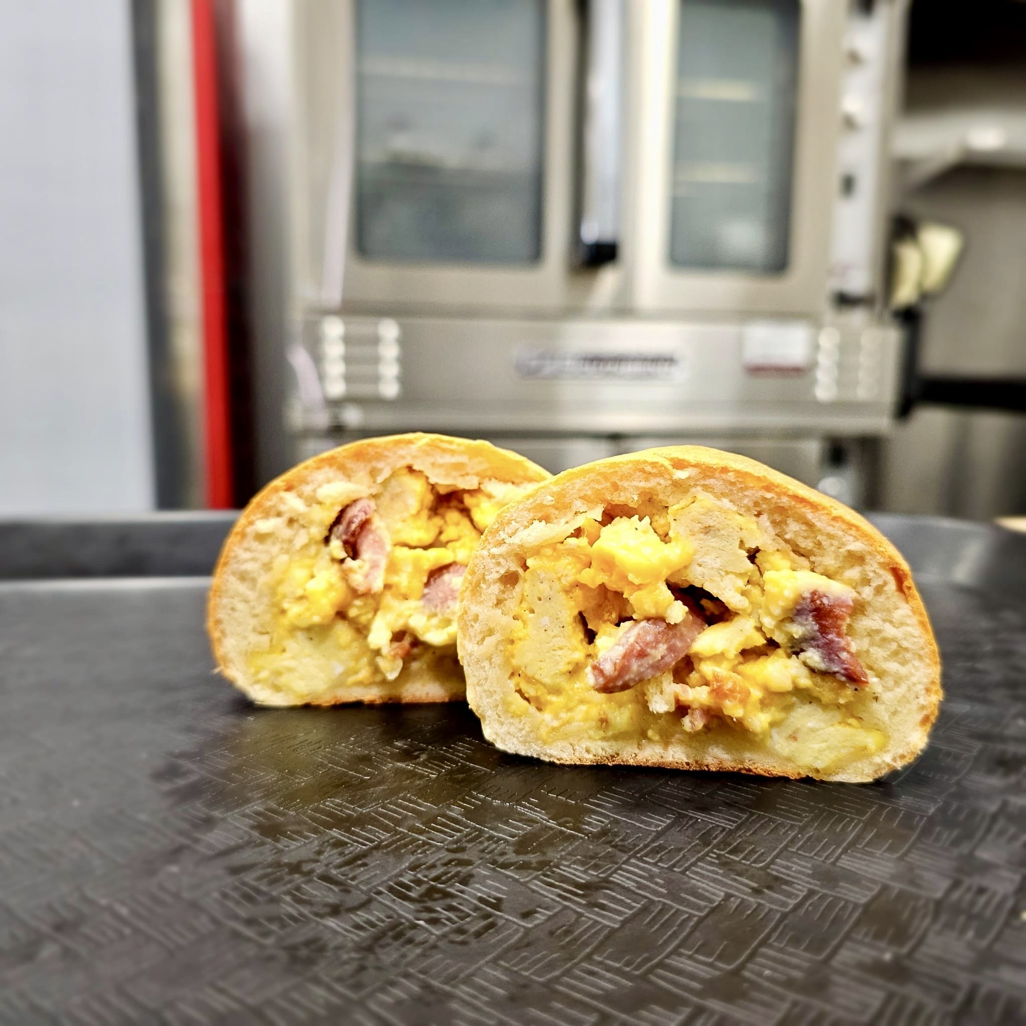Savory kolache cut open showing egg and sausage filling